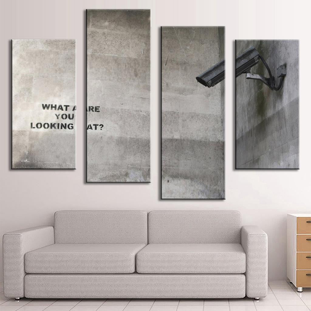 What Are You Looking At Banksy canvas wall art featuring security cameras and graffiti text on concrete wall, split into 4 panels, modern street art style in grayscale tones