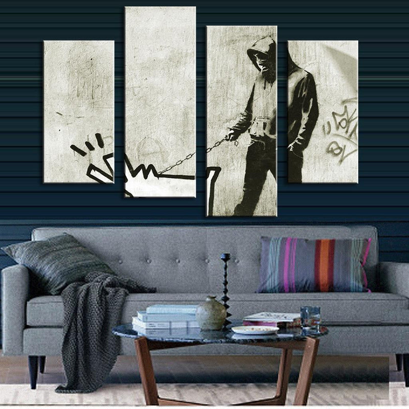 Walk the Dog Banksy 4-panel canvas wall art showing graffiti artwork in black and white, featuring silhouetted figure with dog leash against textured concrete background, modern urban street art displayed above grey sofa