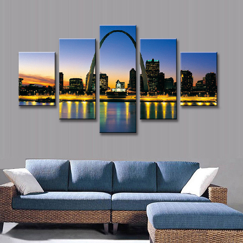 St. Louis Cityscape at Night featuring iconic Gateway Arch silhouetted against vibrant sunset sky, with illuminated downtown buildings reflecting on Mississippi River, creating stunning panoramic view in golden evening light