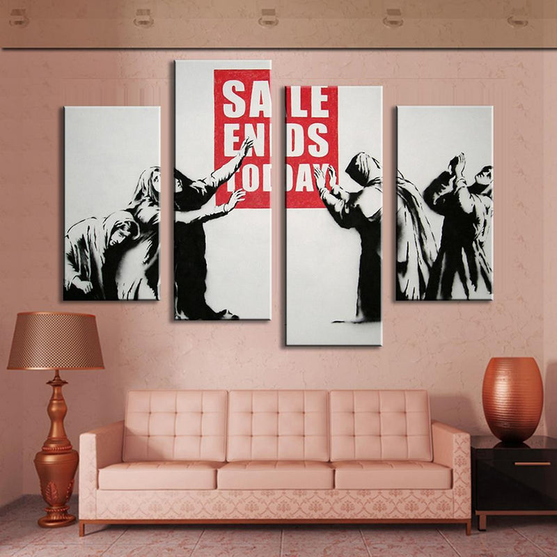 Banksy Sale Ends Today 4-panel canvas wall art showing figures in black and white reaching for a red sale sign, displayed above a pink sofa with decorative lamp and vase, perfect for modern home decor