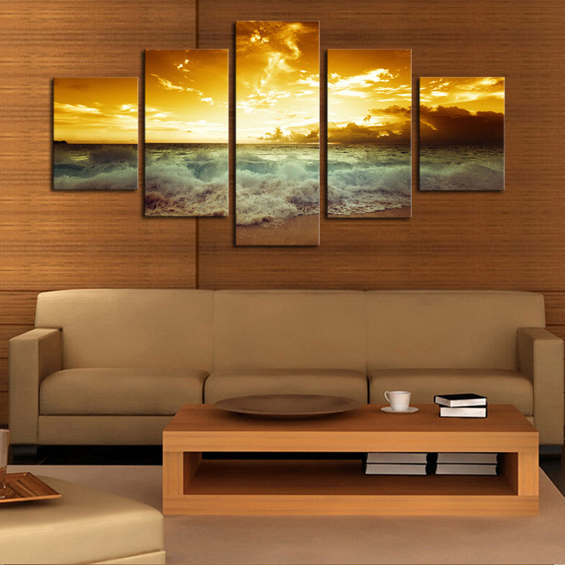 Crashing Waves in the Sunset - 5 panel canvas wall art displaying dramatic ocean waves beneath a golden sunset sky with billowing clouds, perfect coastal decor for living room
