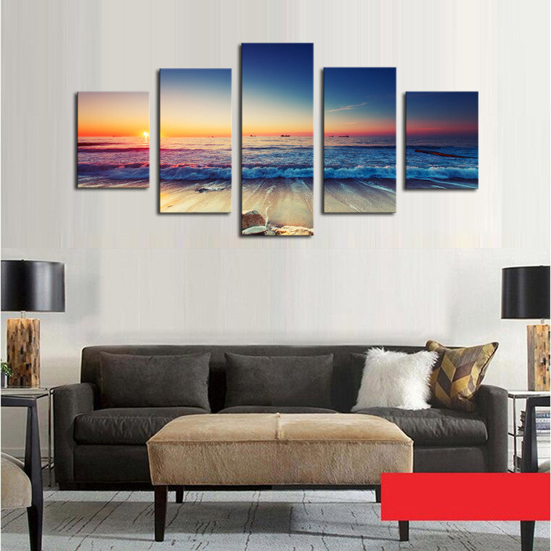 Waves and Sunset Scene: Five-panel canvas wall art displaying dramatic ocean waves crashing on beach at sunset, vibrant orange and blue sky reflecting on water, perfect coastal home decor art measuring 60x32 inches