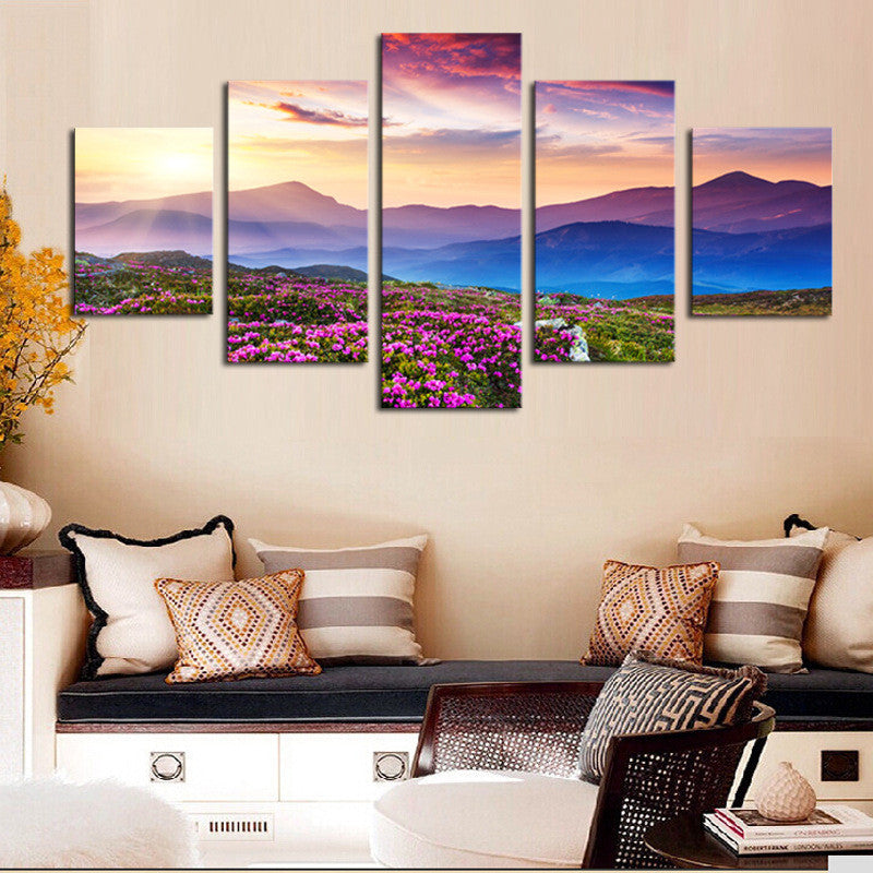 Mountainview Sunset canvas print featuring vibrant purple wildflowers in foreground with layered mountain silhouettes against dramatic pink and orange sunset sky, displayed as 5-panel wall art arrangement