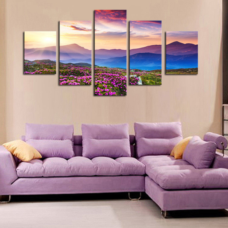 Mountainview Sunset canvas wall art displaying vibrant purple wildflowers in foreground with majestic mountain ranges layered in misty purple and blue hues beneath a dramatic pink and orange sunset sky, split into 5 panels