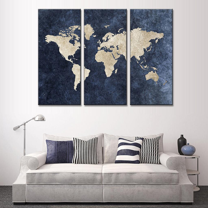 World Map on Navy Canvas featuring a three-panel wall art with cream-colored continents against a deep navy blue textured background, displayed above a modern white sofa, perfect for contemporary home decor
