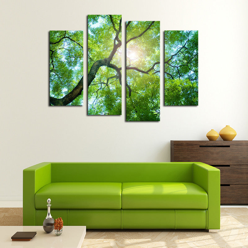 Sunlight Behind Tree - 4-panel canvas wall art featuring bright sunlight filtering through lush green tree branches, creating a peaceful forest canopy view captured from below against blue sky
