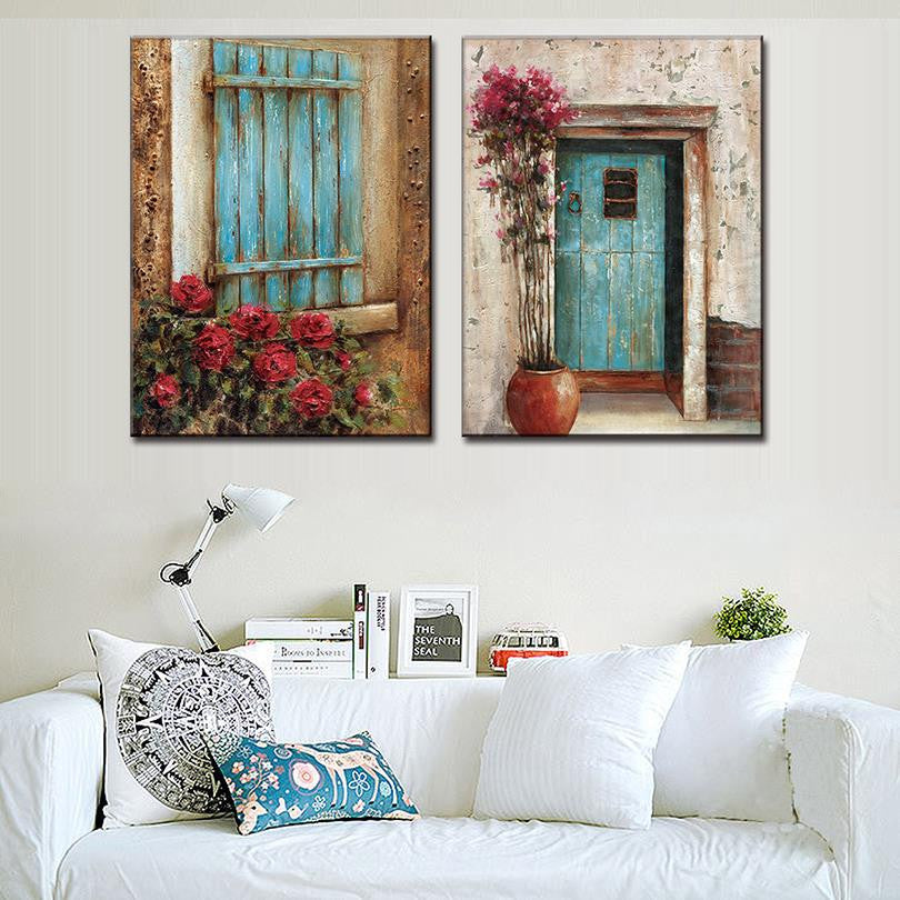 Abstract Window Door Design - Rustic wall art featuring two panels with turquoise wooden elements: a weathered shutter with red roses and a distressed door with pink climbing flowers in terra cotta pot, set against textured beige walls