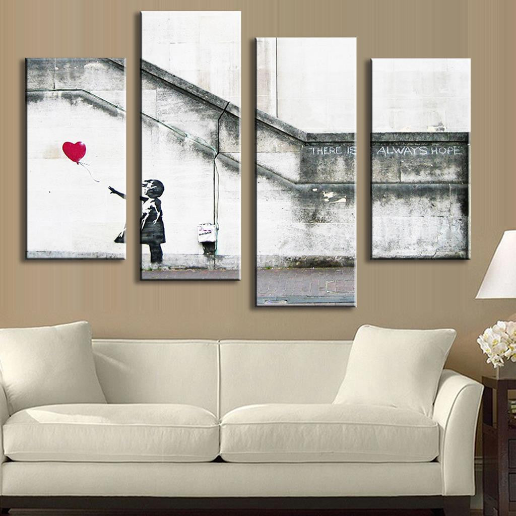 There is Always Hope by Banksy - 4 panel wall art canvas depicting a black and white urban scene with a red heart-shaped balloon against a concrete wall, displayed above a white sofa in modern living room setting