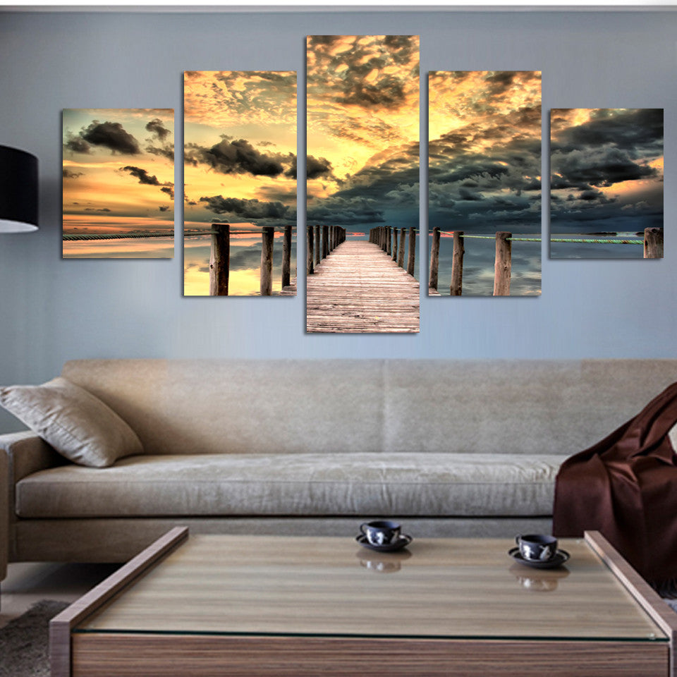 Dock and Seascape canvas panel art featuring a wooden pier stretching into the ocean at sunset, with dramatic golden clouds and dark stormy skies reflected in the calm waters