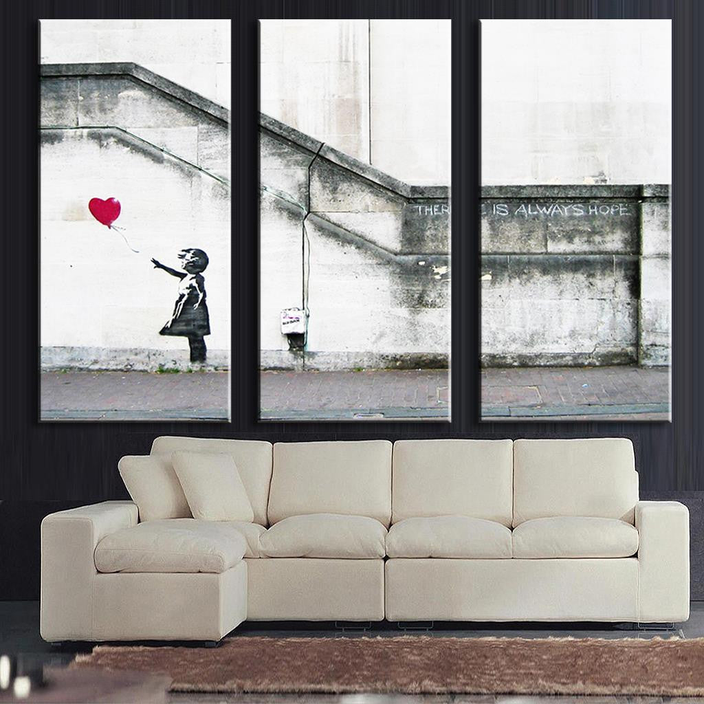 There is Always Hope Banksy street art canvas print showing a girl reaching for a red heart-shaped balloon against a gray urban wall, displayed as three panel wall art for modern home decor