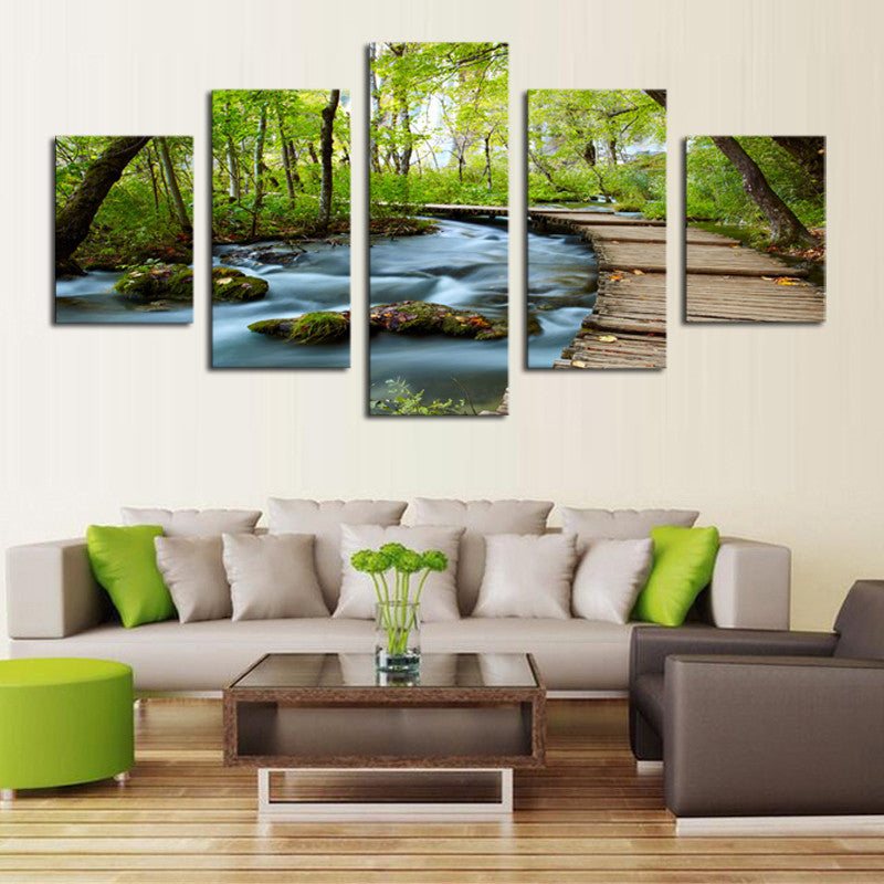 Woods and Waterfalls - 5-panel canvas art showing a serene forest stream with mossy rocks and wooden pathway, surrounded by lush green trees and flowing water creating a tranquil nature scene perfect for home decor